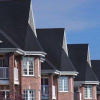 A large apartment building and a blue sky.